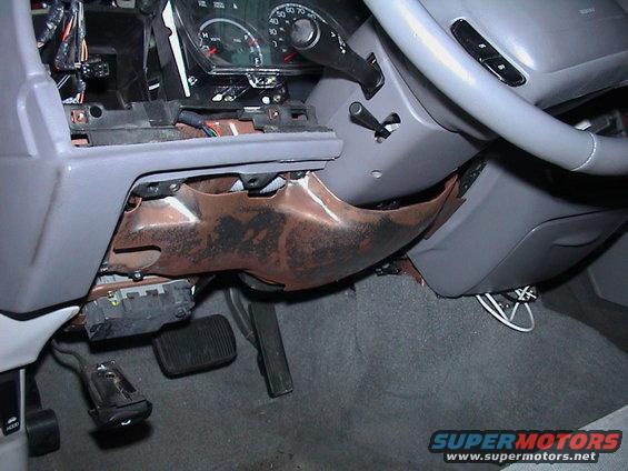 2000 Ford Crown Victoria interior showing exposed dashboard components, steering column, and pedals