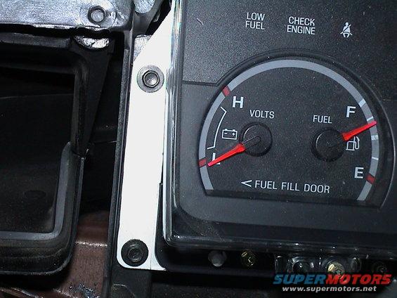 Dashboard gauges showing volts and fuel level, with 'LOW FUEL' and 'CHECK ENGINE' indicators