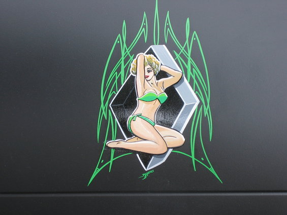 Black vehicle with green pinstriping and a pin-up girl graphic in a green bikini