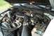 1988 Ford Bronco - The engine bay of a vehicle is shown with various mechanical parts and wiring harnesses.