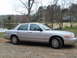 2004 Ford Crown Victoria - Side view of a silver 2004 Ford Crown Victoria parked outdoors near a lake.