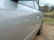 2004 Ford Crown Victoria - A silver sedan is viewed from the side, parked near a body of water.