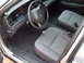 2004 Ford Crown Victoria - The interior of a 2004 Ford Crown Victoria, cloth seats and a standard dashboard layout.