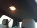 2004 Ford Crown Victoria - Interior shot of a car's headliner and rear seating area, with a dome light illuminated.