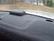 2004 Ford Crown Victoria - Close-up of a car's rear deck, showing a speaker cover and the rear window.