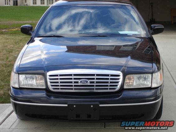 Front view of a black 2001 Ford Crown Victoria with a chrome grille and Ford logo