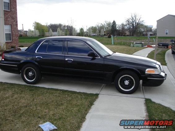 Black 2001 Ford Crown Victoria parked on a concrete driveway