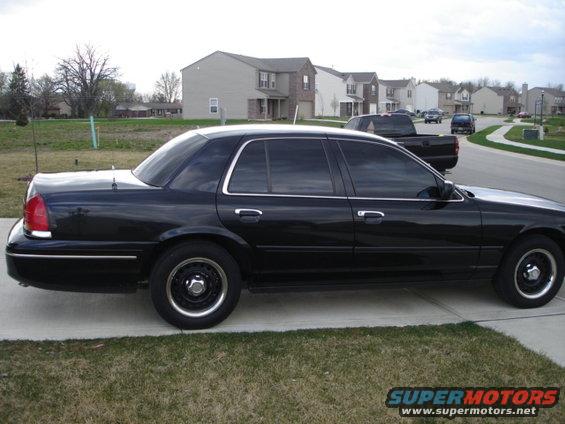 Black 2001 Ford Crown Victoria parked on a driveway, side view