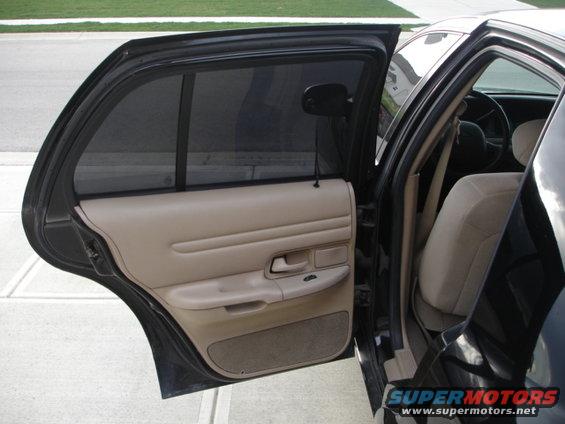 Interior shot of a 2001 Ford Crown Victoria, showing the front passenger seat and door panel