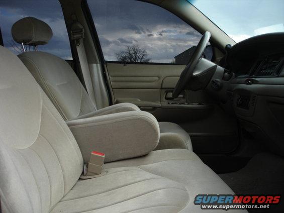 Interior view of a beige sedan with bucket seats and a center console