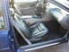 1995 Ford Thunderbird - Interior view of a blue car, focusing on the front seats and dashboard area.