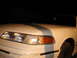 1992 Ford Crown Victoria - Front view of a white 1992 Ford Crown Victoria, highlighting its distinctive headlights and grille.