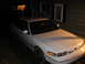 1992 Ford Crown Victoria - A white 1992 Ford Crown Victoria is parked in front of a house at night.