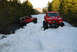 1989 Ford Bronco - A red 1966 Ford Bronco navigates a snowy trail, with another off-road vehicle visible in the background.