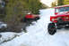 1989 Ford Bronco - Two off-road vehicles navigate a snowy landscape, one climbing a snowbank while the other is in a ditch.