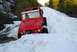 1989 Ford Bronco - A red 1978 Ford Bronco navigates a snow-covered mountain path.