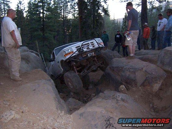 1995 Ford Bronco navigating rocky terrain, front-mounted winch visible