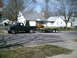 2001 Dodge 2500 - A dark blue 2001 Dodge 2500 pickup truck is seen from the side, towing a utility trailer on a residential street.