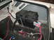 1985 Ford Crown Victoria LTD - The trunk interior displays a battery, fuel lines, and wiring, with a 'Supermotors' logo visible.