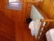 1978 Ford Bronco - The interior of a room features a wooden bunk bed with a mattress and bedding, set against wood-paneled walls.