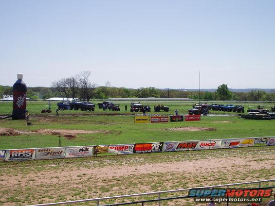 Off-road vehicles gathered at an event with a giant Dr Pepper bottle