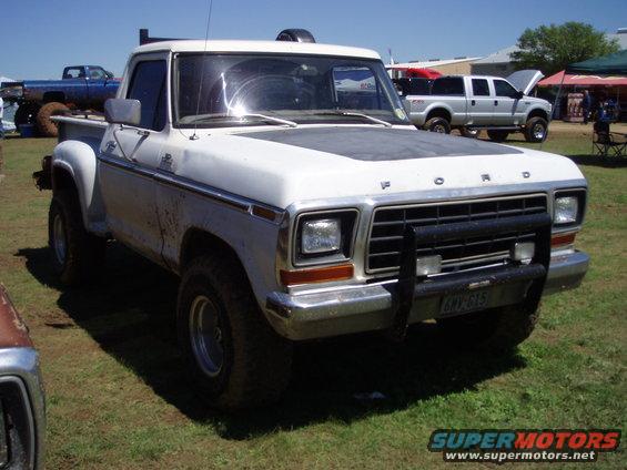 White 1978 Ford F-150 pickup truck with a black grille guard and aftermarket wheels
