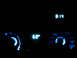 1995 Ford Thunderbird - The illuminated climate controls and clock display glow blue in the dark interior of a vehicle.