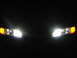 1995 Ford Thunderbird - Headlights with amber turn signals are illuminated against a dark background.