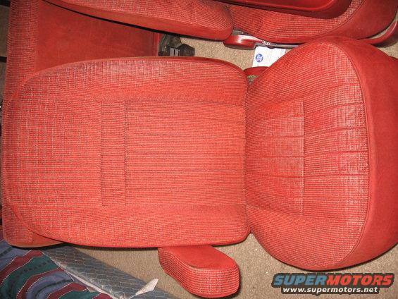 Red patterned car seats with a center console armrest visible