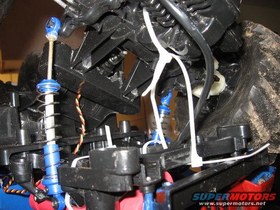 Close-up of suspension parts and wiring on a remote control car