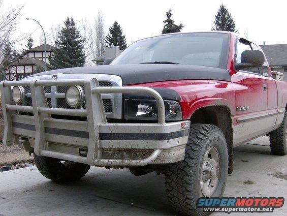 red pickup truck with black hood and bull bar