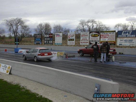 Red 1998 Ford Crown Victoria at drag strip
