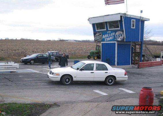 White 1998 Ford Crown Victoria sedan on a race track