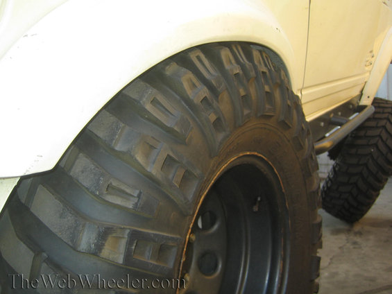 Off-road tire and white fender flare on a vehicle