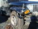 1996 Ford Bronco - This Jeep Wrangler has significant damage to its front passenger side fender and a flat tire.