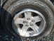 1996 Ford Bronco - A flat tire with a damaged rim is visible on a vehicle.