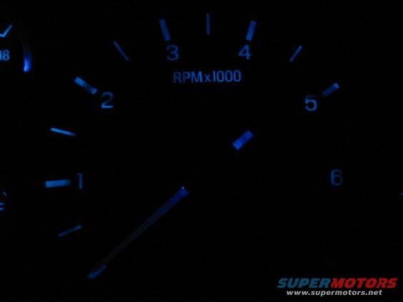 Blue tachometer gauge with RPM x1000 indicator and needle pointing to 3