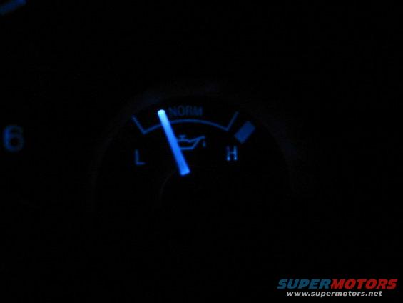 Blue oil pressure gauge with needle pointing to low
