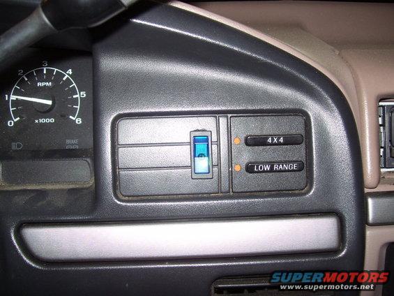 Dashboard with tachometer, 4x4 and low range buttons, and a blue indicator light