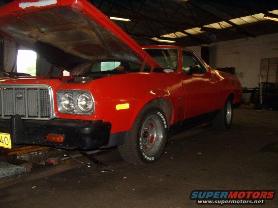 Red 1974 Ford Ranchero with hood open, front 3/4 view