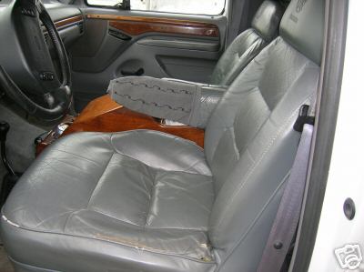 Gray leather seats and wood trim interior of a 1990s Ford truck