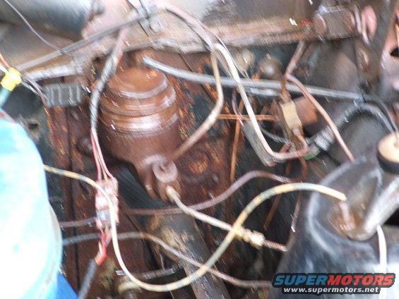 Rusted engine bay with brake master cylinder and wiring