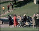 1970 Mercury Cougar - A convertible car and a motorcycle are visible on a street with several people around.