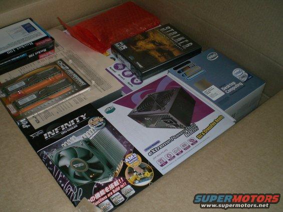 Box of computer parts including RAM, CPU cooler, and power supply