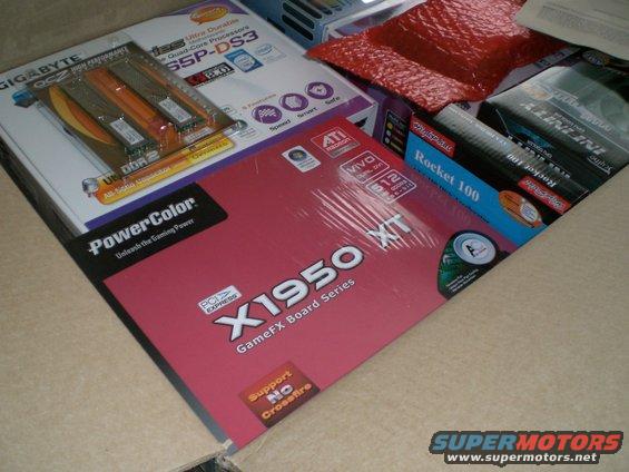 Box of computer components including PowerColor X1950 XT and Gigabyte motherboard