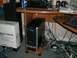 1995 Ford Probe - A computer tower sits on a stand beside a box, with a desk and messy cables visible.
