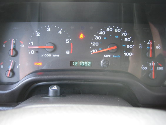 Vehicle dashboard with speedometer, tachometer, and odometer showing 121092
