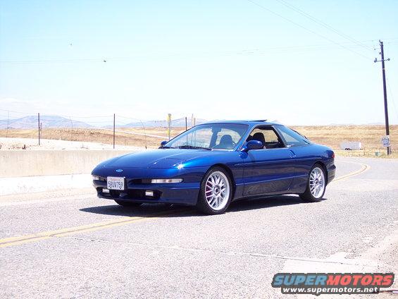 Blue 1995 Ford Probe driving on a road