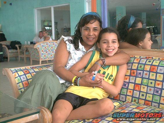 Woman and girl on couch, girl wears yellow jersey with 'Jamaica' text