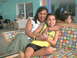 2003 Yamaha RAPTOR 80 - A woman embraces a smiling girl sitting on a colorful couch. The girl wears a yellow jersey with 'Jamaica' visible on it.
